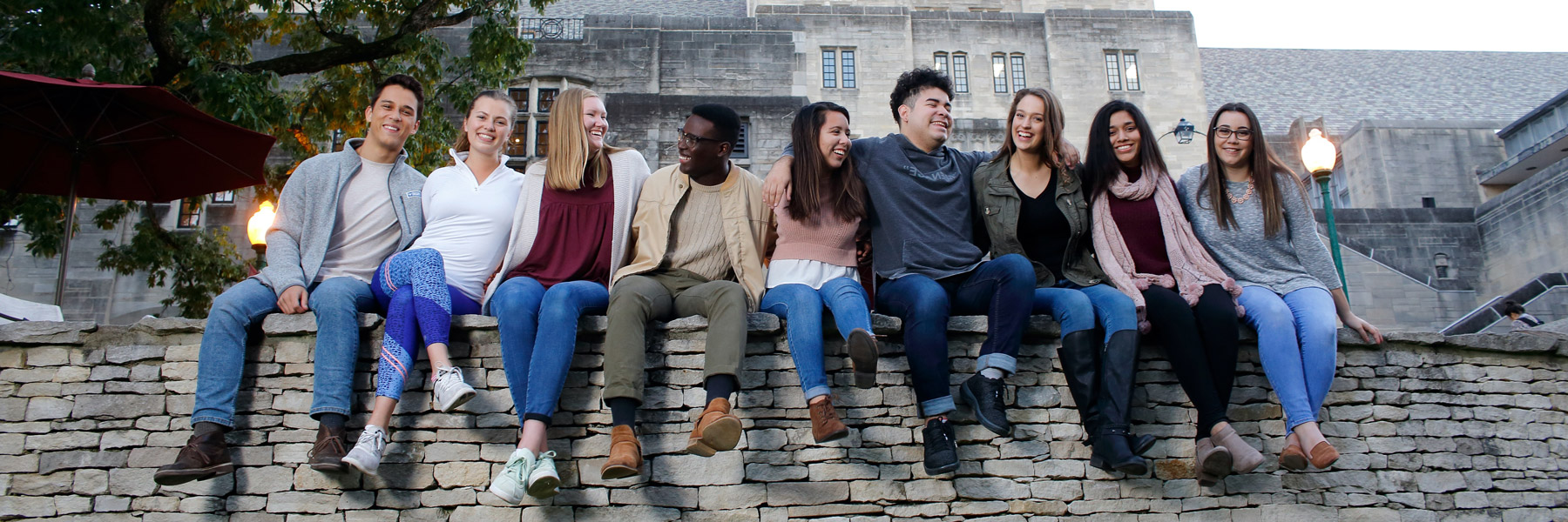 A group of students sitting on a wall